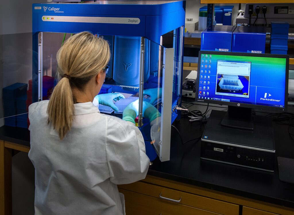 person in a healthcare lab at a computer