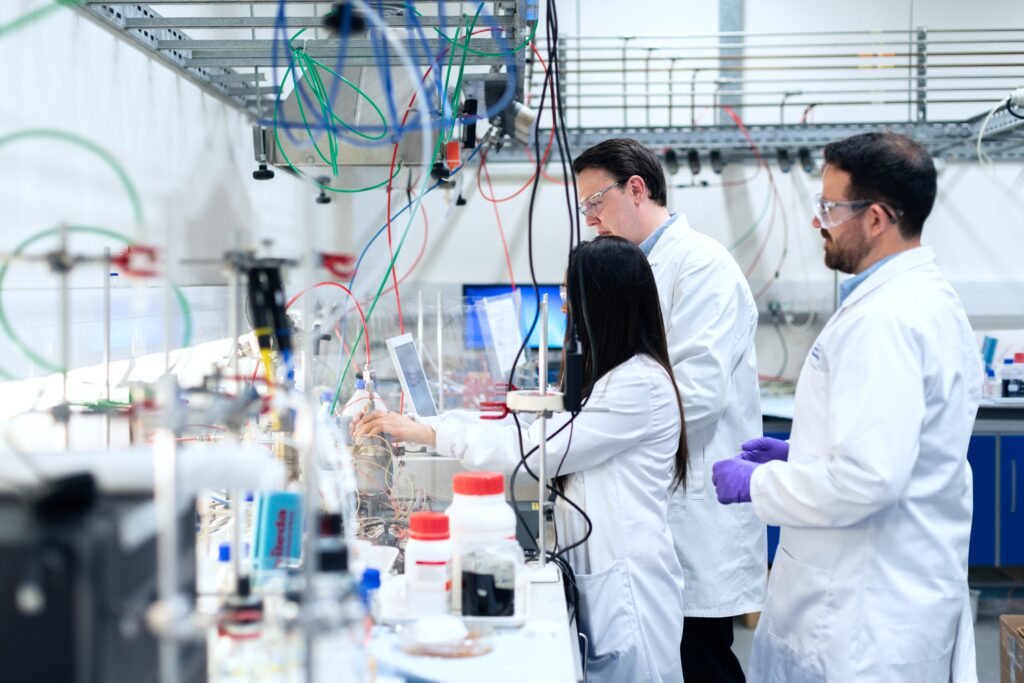 3 people working at a lab research station