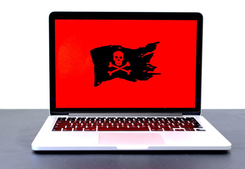 laptop with a pirate flag showing malware