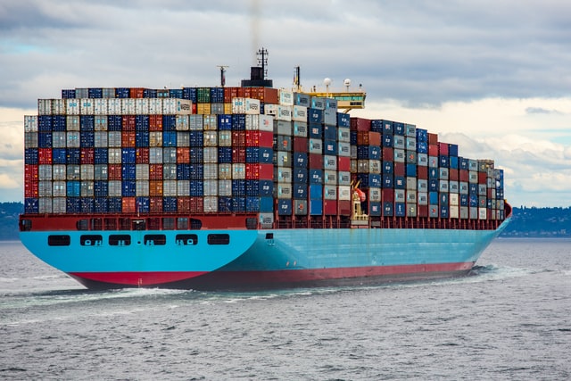 large ship vessel with shipping containers at sea