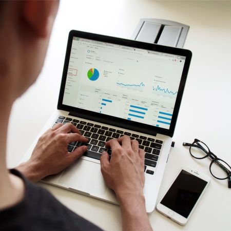 Person using laptop to view a report Person using laptop to view a report